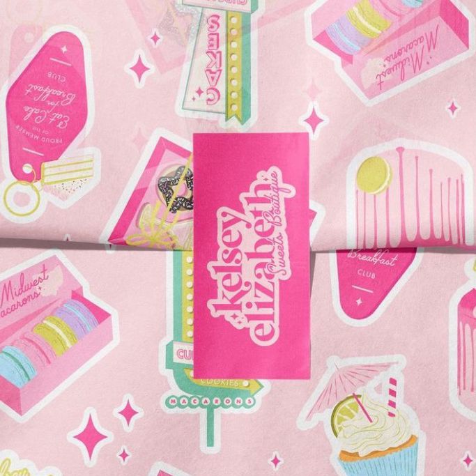 Wrapping paper mockup with a pink background, featuring pastel dessert illustrations and a bright pink sticker with white text.
