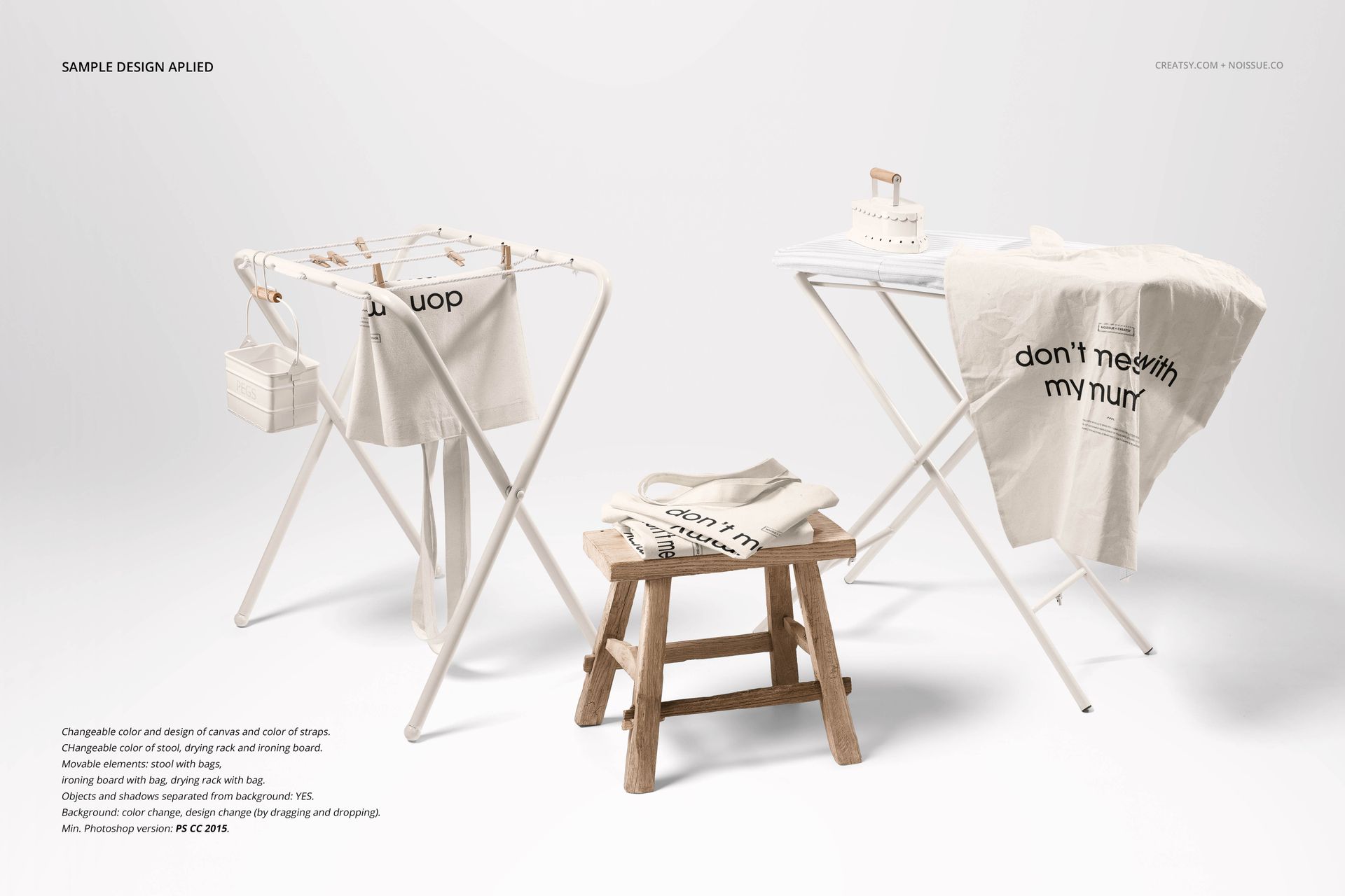 Mockup of beige tote bags with black lettering arranged on white stands and a stool against a plain background.