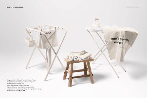 Mockup of beige tote bags with black lettering arranged on white stands and a stool against a plain background.