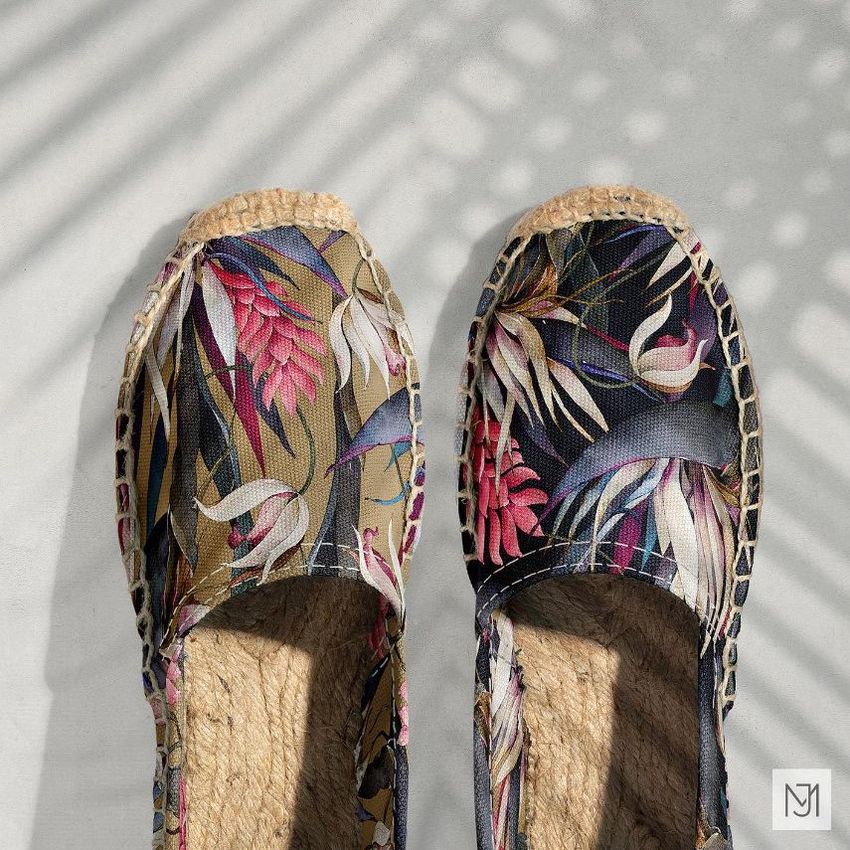 Canvas espadrilles mockup featuring a pair of shoes with a colorful tropical leaf pattern, shown from above on a light surface.