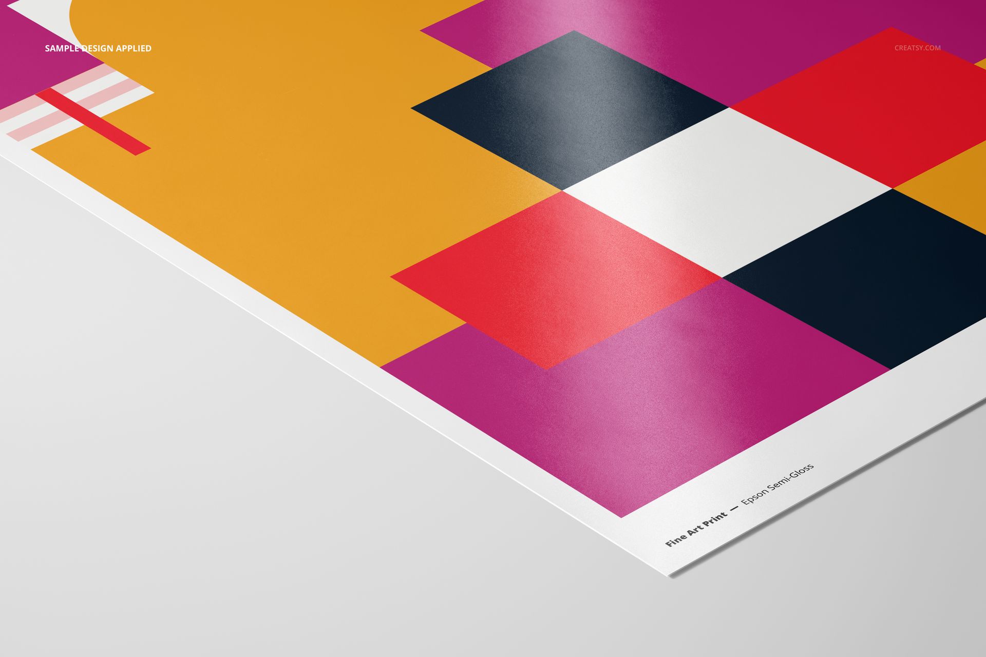 Close-up of an A3 print mockup featuring colorful geometric shapes on semi-gloss paper, angled on a light surface.