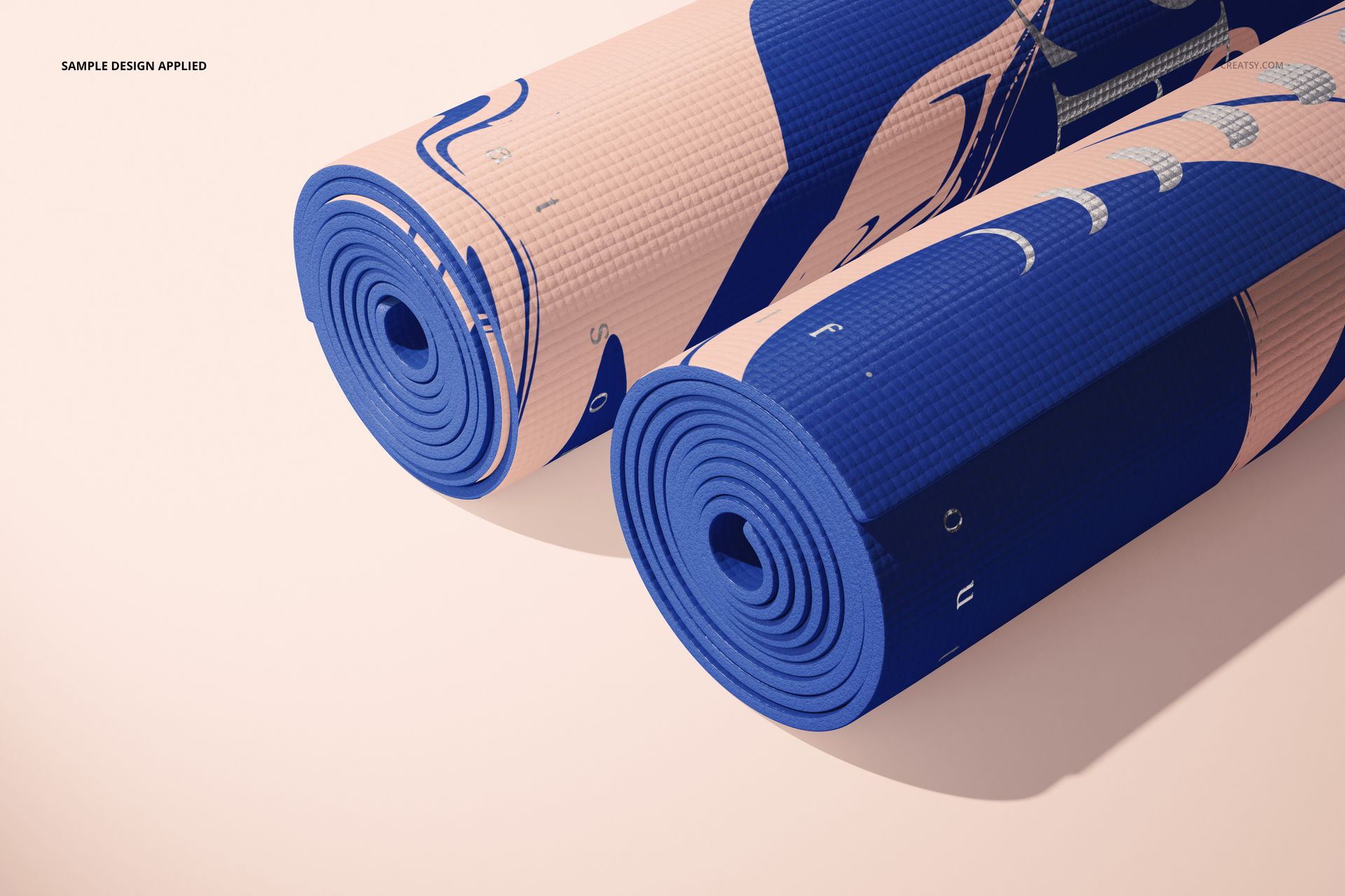 Sport equipment mockup showing two yoga mats with modern blue and pink artwork, displayed in a studio setting.