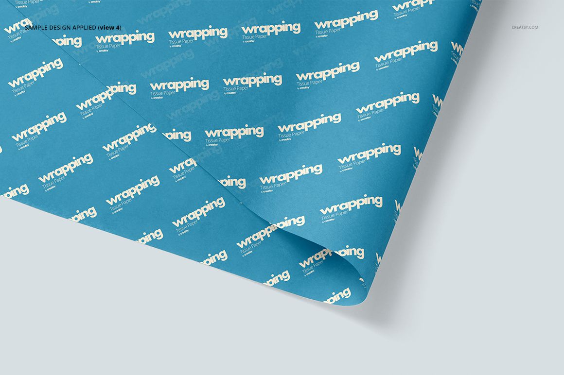 Wrapping tissue paper mockup featuring a blue sheet with diagonal white text, displayed from a top perspective.