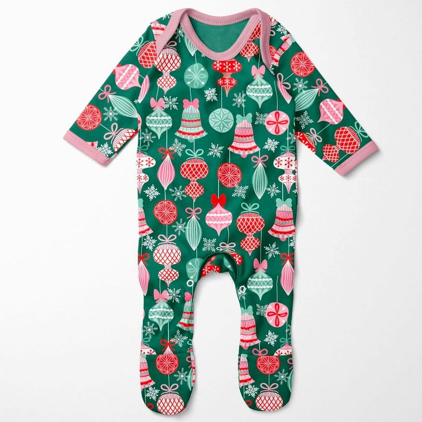 Baby chest rompersuit mockup featuring a green one-piece with colorful holiday ornaments and snowflakes on a plain background.