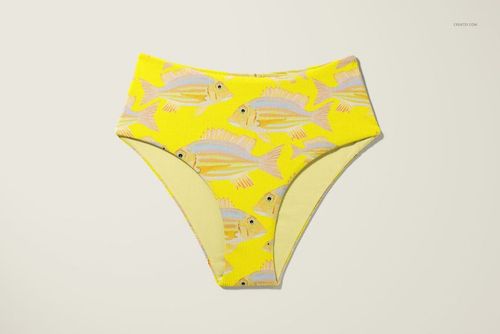 High waisted bikini bottom mockup with a yellow background and fish pattern, shown from the front on a light surface.