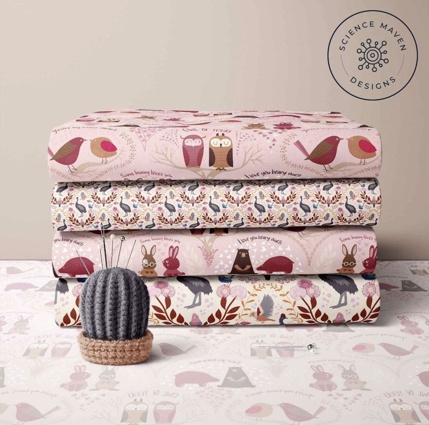 Folded fabrics mockup showing four stacked fabric pieces with whimsical animal and nature patterns in soft pastel colors.