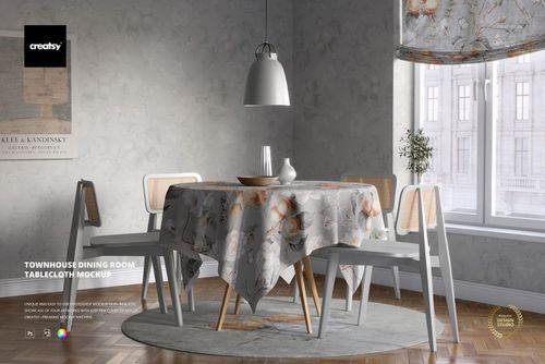 Elegant dining table mockup with floral tablecloth, ceramic dishes, and neutral decor in a sunlit room with large windows.
