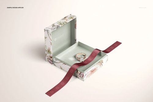 Floral-patterned jewelry box mockup with lid open, ring displayed inside, and maroon ribbon placed across the base.