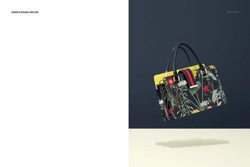 Leather handbag PSD mockup with floral design, yellow trim, and black handles, shown from the front on a neutral surface.