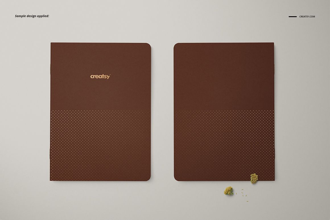 A5 notebook mockup set showing two brown covers, one open and one closed, with minimal props on a pale surface.