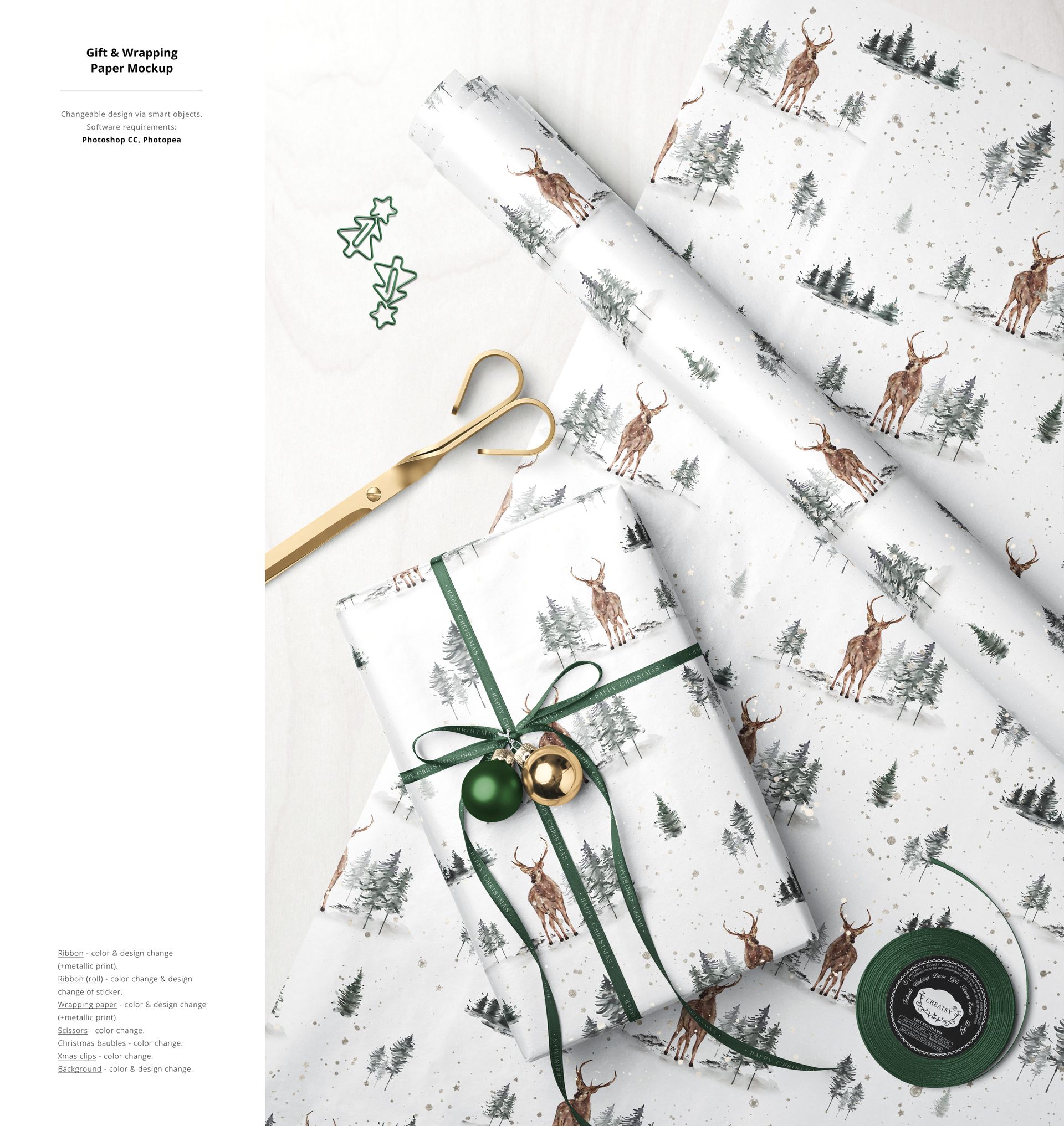 Top view of Christmas gift wrapping mockup with white paper featuring deer and tree pattern, green ribbon, baubles, scissors, and tape.