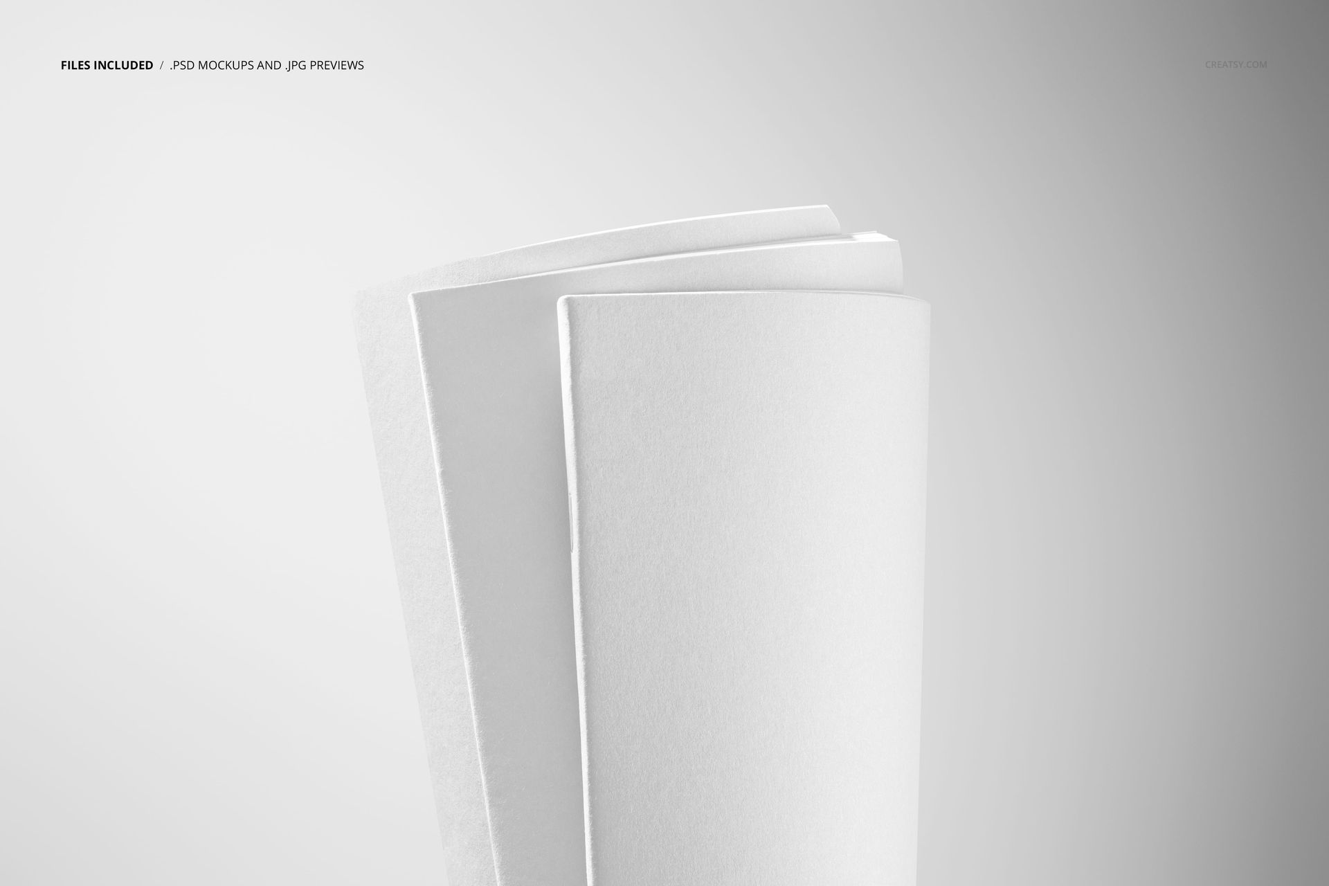 Minimalist stationery mockup featuring three white notebooks arranged vertically, highlighted by soft lighting.