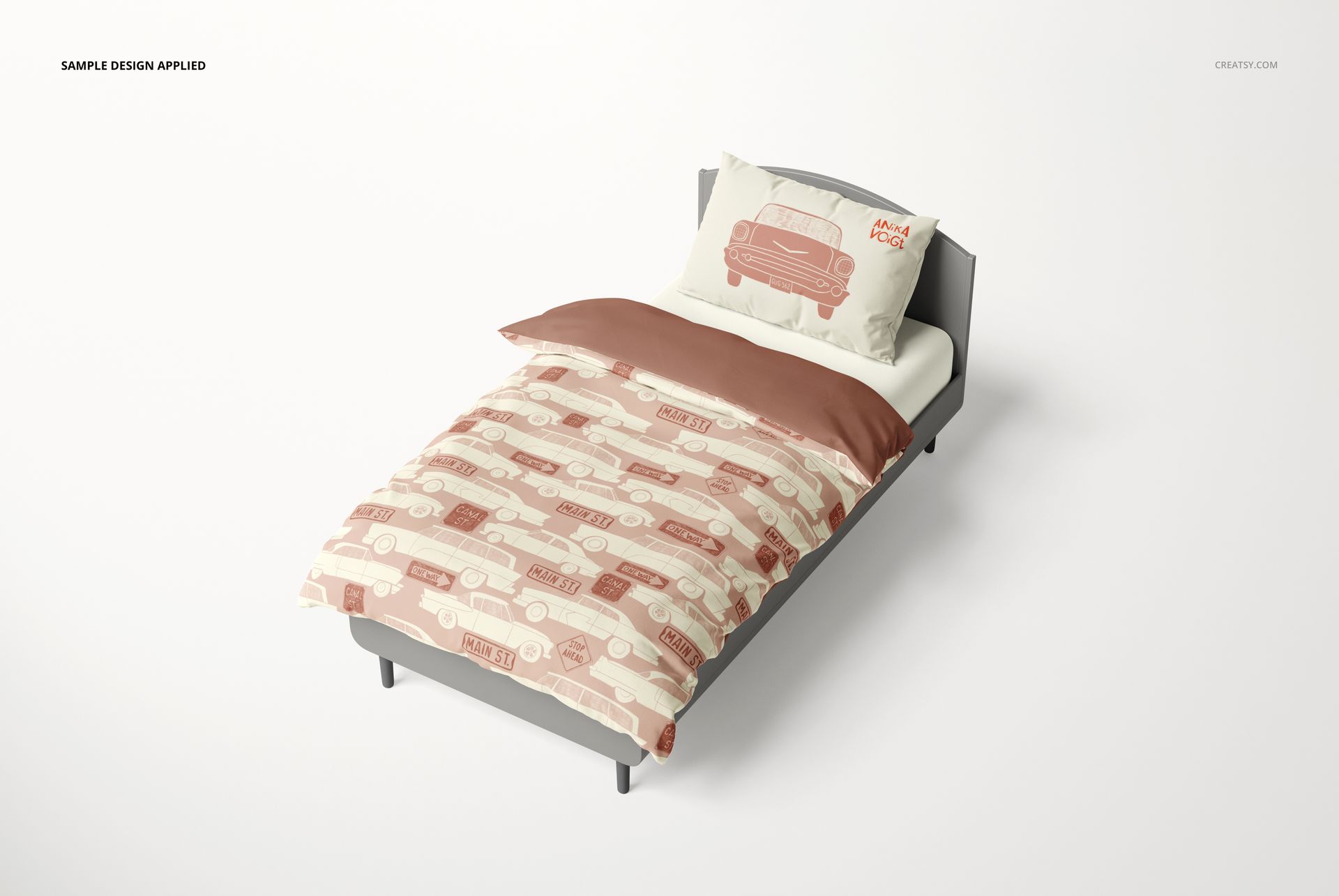 Kids bedding mockup featuring a single bed with car-themed patterns in beige and brown, viewed from above at an angle.