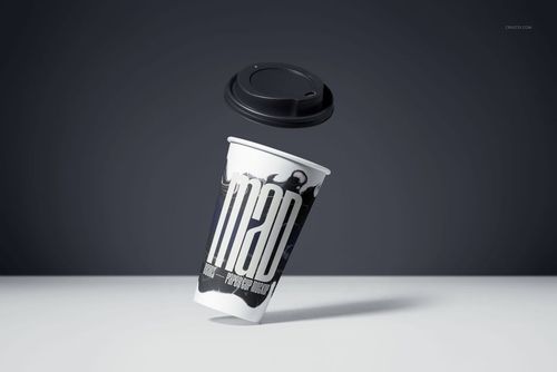 PSD mockup of a paper drinkware cup with modern monochrome artwork, lid hovering above, set against a minimalist gray backdrop.