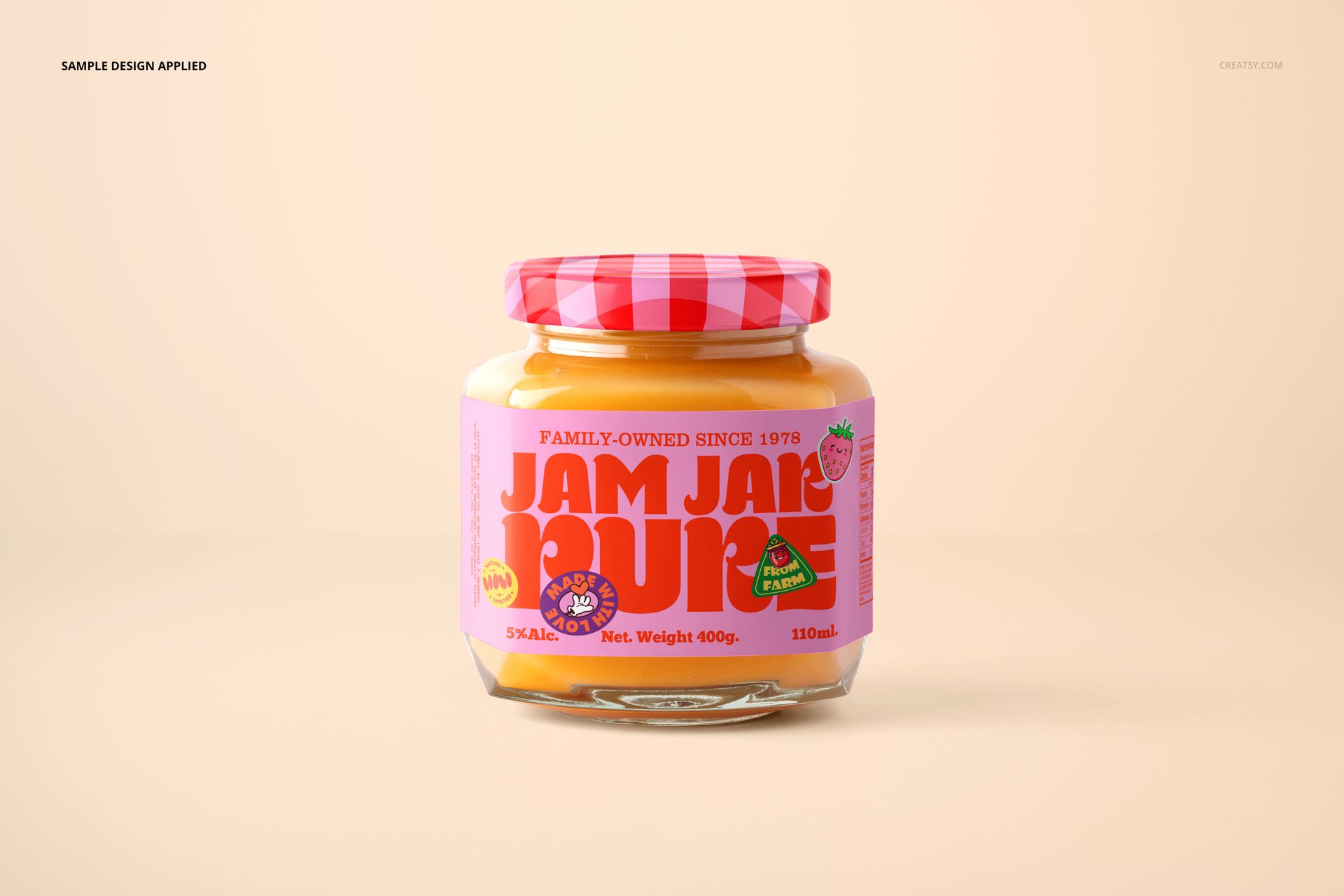 Glass jam jar mockup with a pink patterned lid and vibrant label, displayed against a soft beige surface.