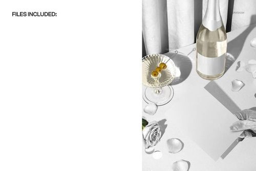 Greeting card mockup displayed on a white surface with velvet curtain, champagne bottle, rose, and scattered petals.