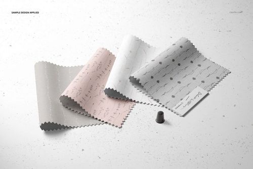 Fabric swatches mockup featuring assorted patterns and shades, shown alongside a thimble and a small label, overhead perspective.