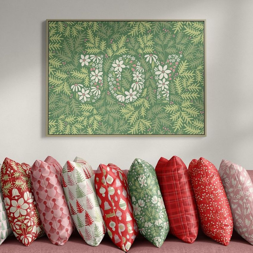 Velvet pillows mockup featuring a row of decorative pillows in red, green, and pink patterns beneath a framed botanical print.