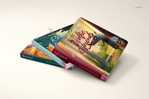 Stacked cardboard baby book mockups with vibrant cover designs, shown in a perspective view on a neutral background.