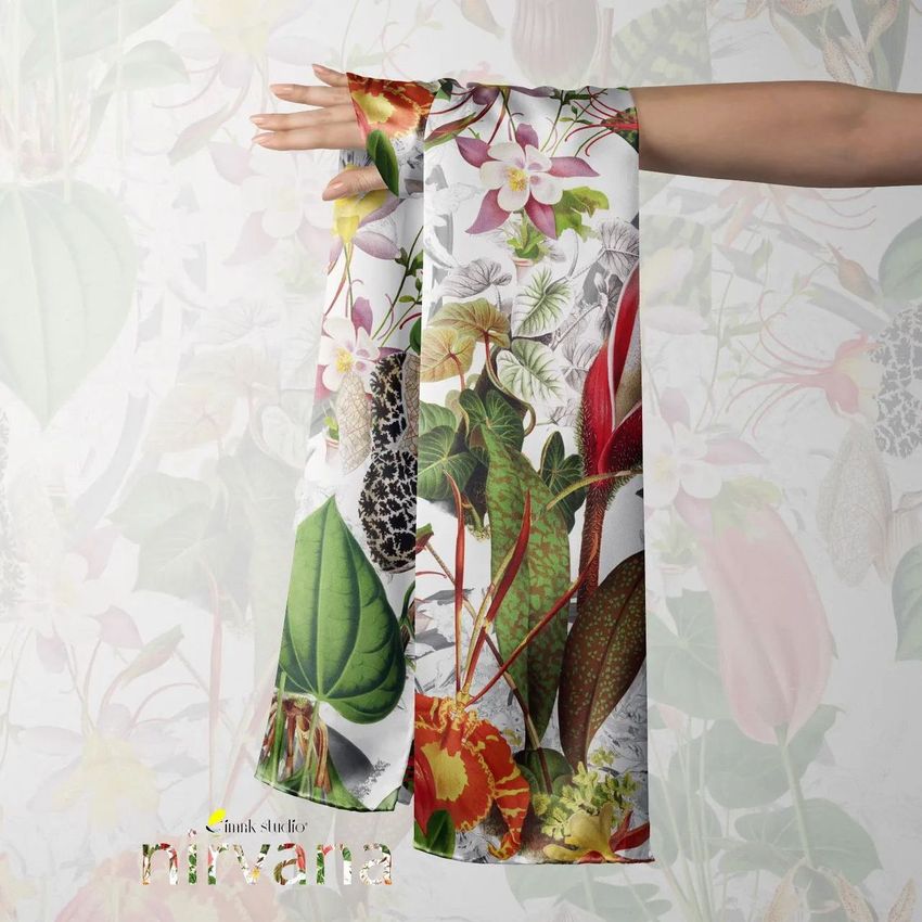 Silk scarf mockup draped over an outstretched hand, featuring a colorful botanical pattern on a light background.