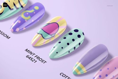 PSD mockup showing a lineup of decorative nail tips in soft shades, some with polka dots and stripes, viewed from above.