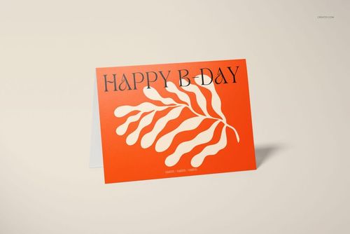 Front view of a 5x7 greeting card mockup with an orange cover, abstract cream leaf design, and bold black text.