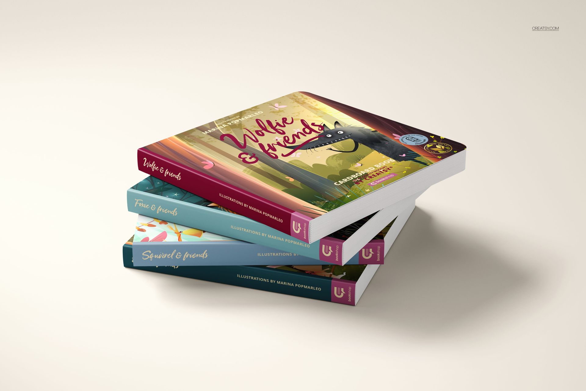 Cardboard baby book mockup set featuring three books with vibrant cover art, stacked diagonally on a neutral background.