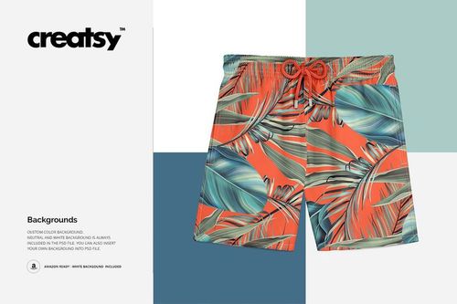 Swim trunks mockup featuring vibrant orange and green tropical leaves, shown from the front on a clean white surface.
