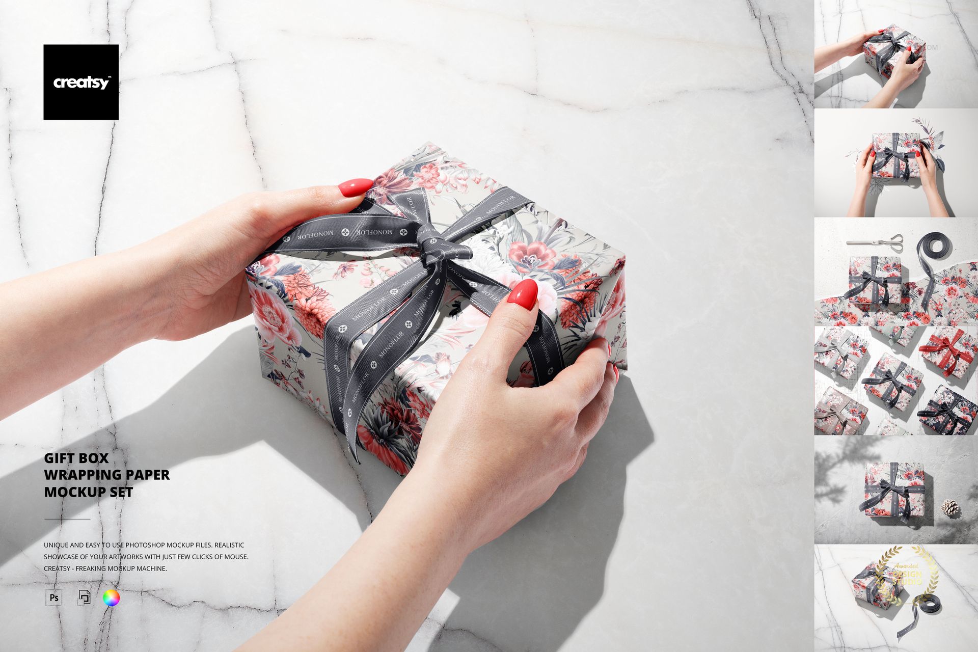 Hands holding a gift box covered in floral wrapping paper and tied with a dark ribbon, marble background, PSD mockup.