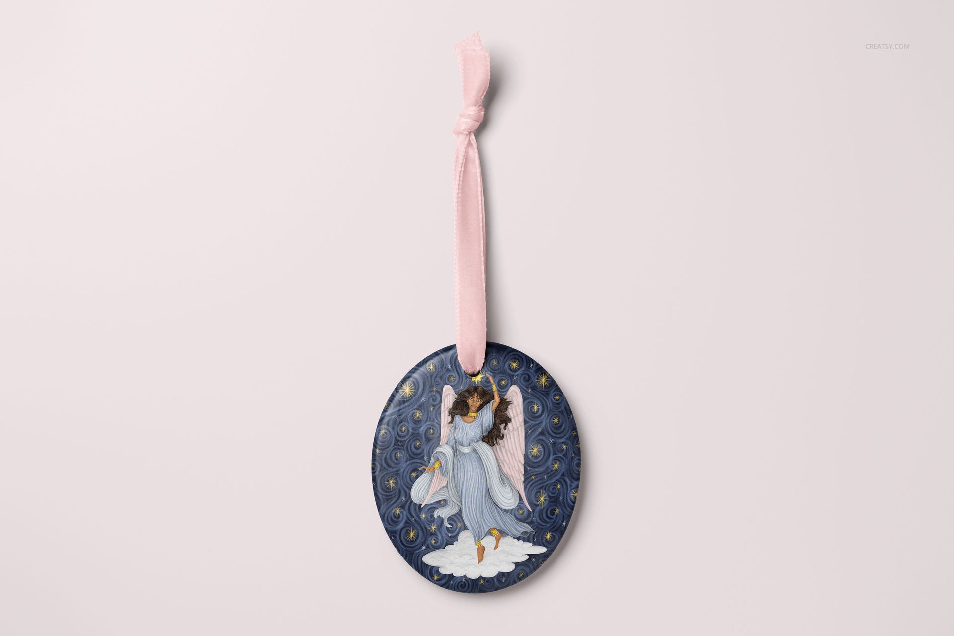 Oval-shaped Christmas ornament mockup featuring an angel illustration on a dark blue background, front view.