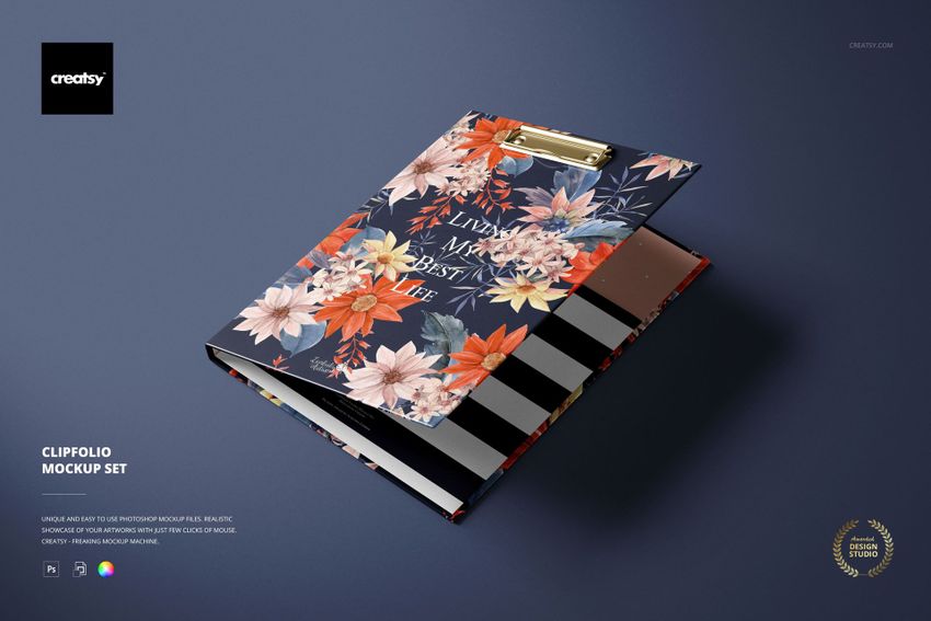 Stationery mockup featuring a floral-patterned clipboard with gold clip, shown from an angled top view on a dark surface.