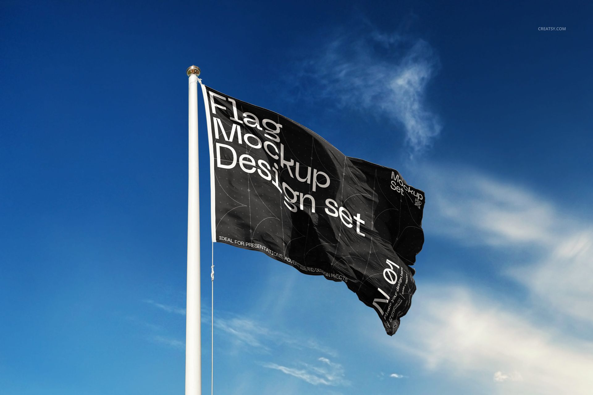 Flag mockup featuring a black fabric flag with bold white lettering, shown outdoors on a vertical pole under blue sky.