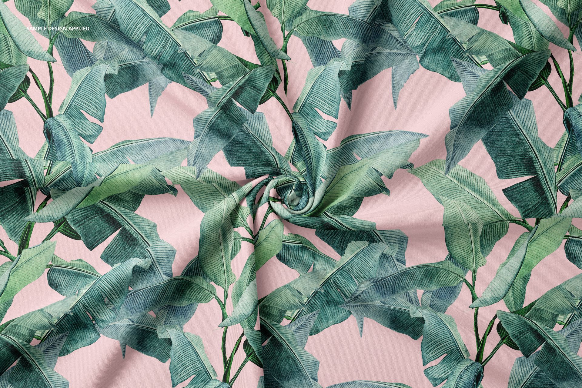 Twisted jersey fabric mockup featuring a green tropical leaf pattern on a soft pink background, top view.