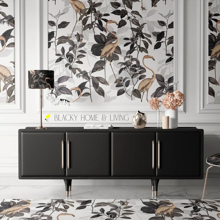 Canvas print mockup showing a modern interior with a black sideboard, floral wallpaper, and decorative objects in neutral tones.