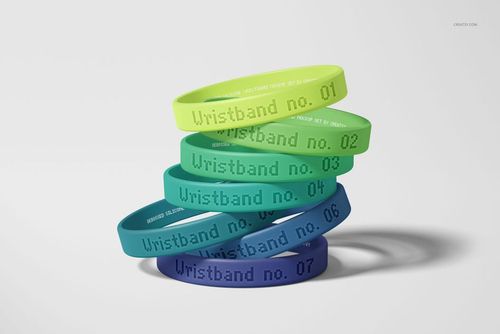 Front view of colorful silicone wristbands mockup, featuring debossed text and realistic shadows on a neutral surface.