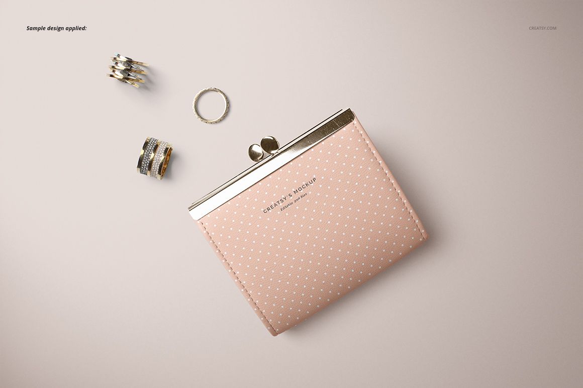 Leather wallet purse mockup displayed in top view, featuring a pale pink color and small white dots, with rings beside it.