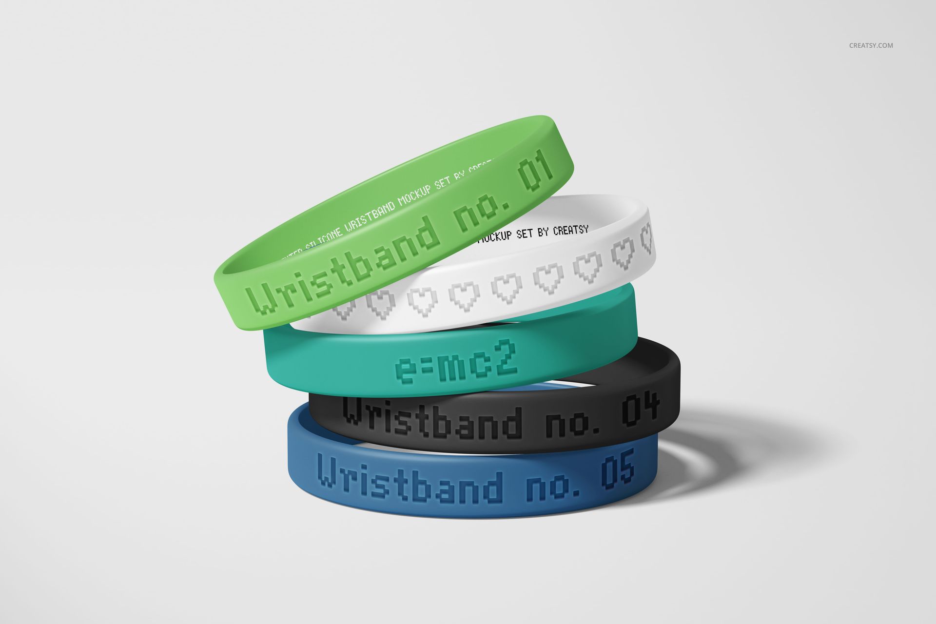 PSD mockup showing five silicone wristbands with various colors and debossed designs, displayed in a pile.