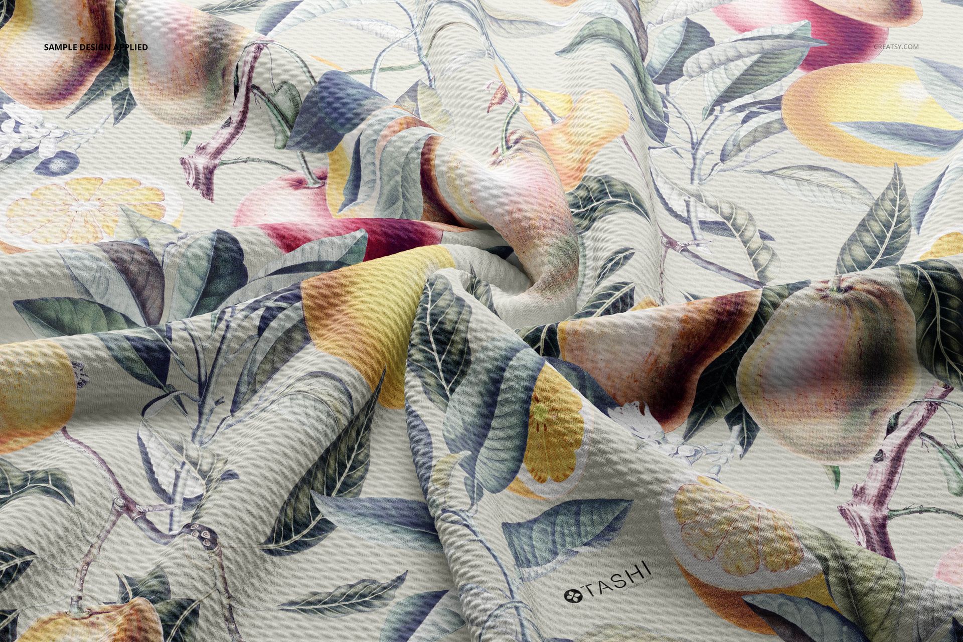 Wrinkled bullet fabric mockup featuring a botanical and fruit pattern with yellow, orange, and green tones, close-up view.