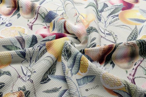 Wrinkled bullet fabric mockup featuring a botanical and fruit pattern with yellow, orange, and green tones, close-up view.