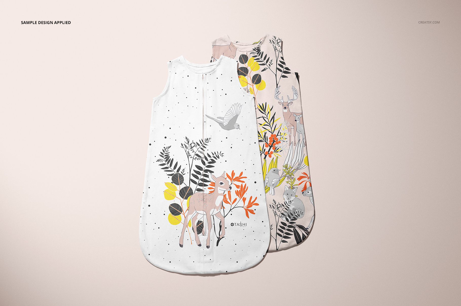 PSD mockup showing a pair of baby wearable blankets with colorful forest-themed designs arranged side by side.