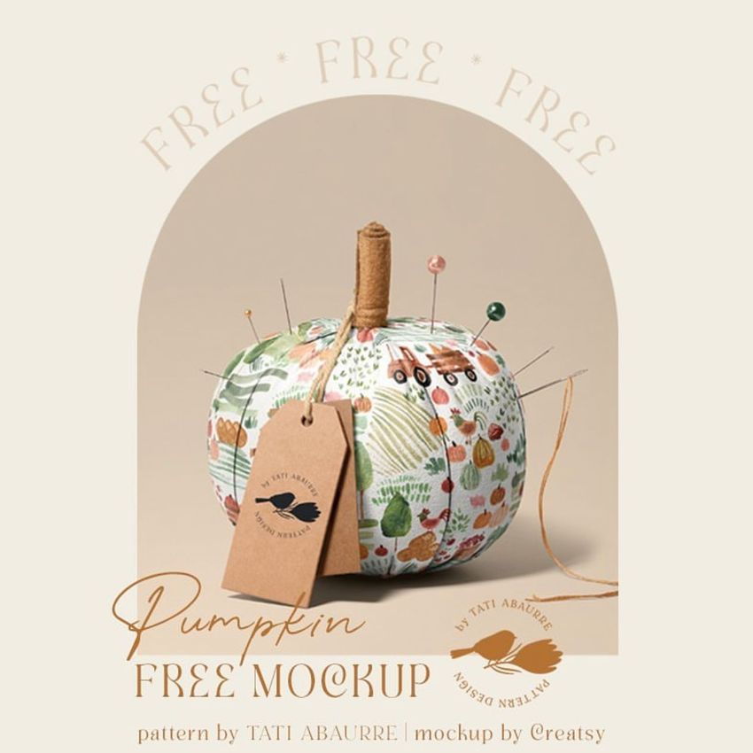 Fabric pumpkin mockup with a country pattern, used as a pincushion with pins and a kraft tag, set against a beige background.