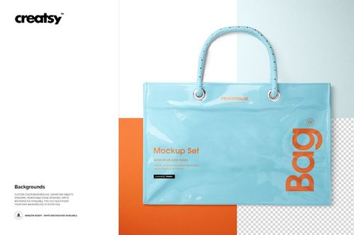 Reusable vinyl PVC tote bag mockup in glossy light blue with orange text, shown from the front on a color-blocked background.