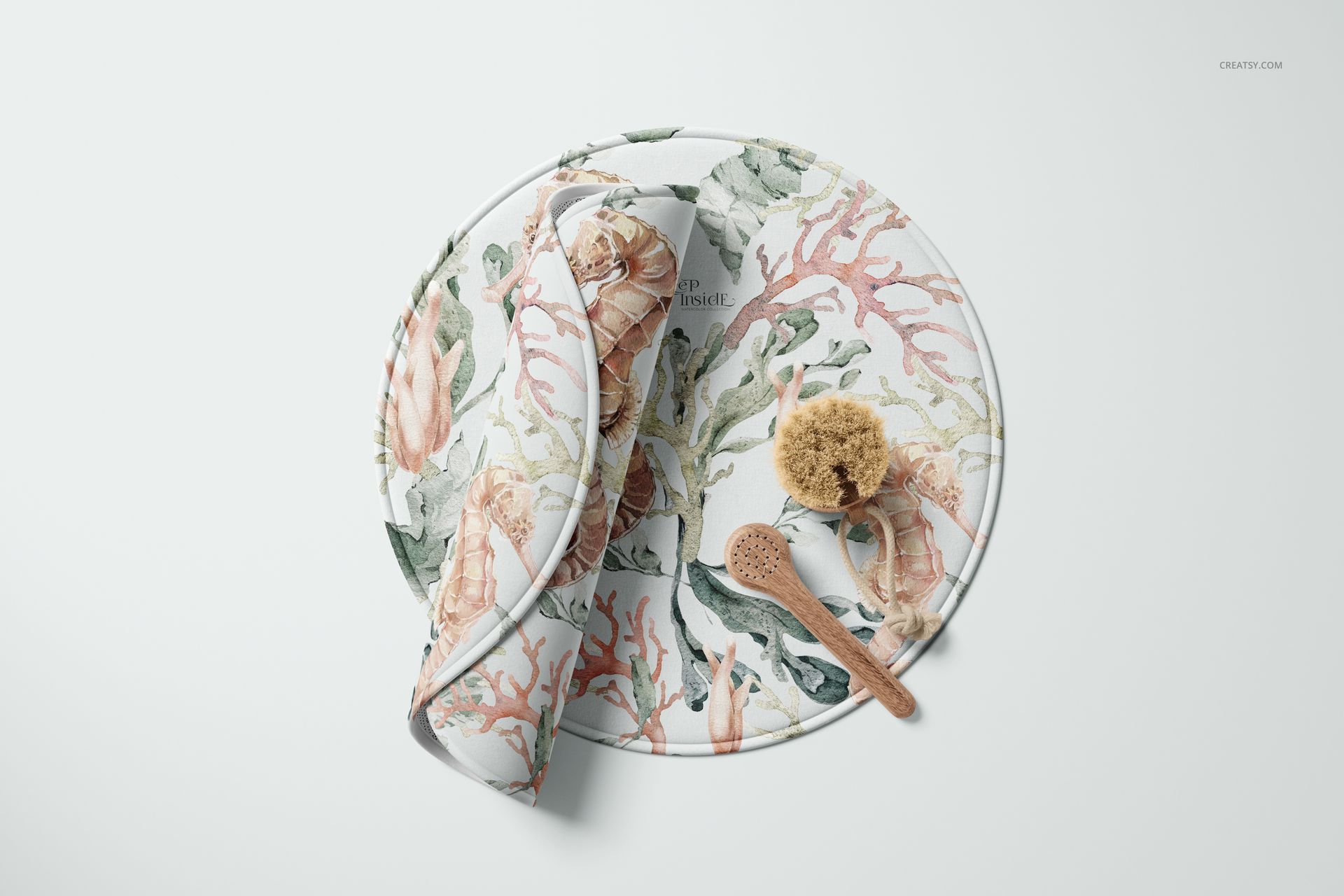 Round polyester bath mat mockup with coral and seashell pattern, shown from a top view with bath accessories.