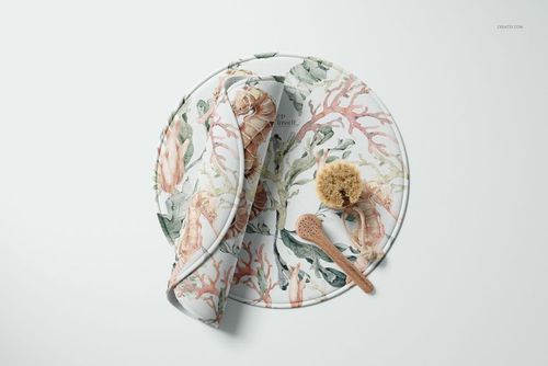 Round polyester bath mat mockup with coral and seashell pattern, shown from a top view with bath accessories.