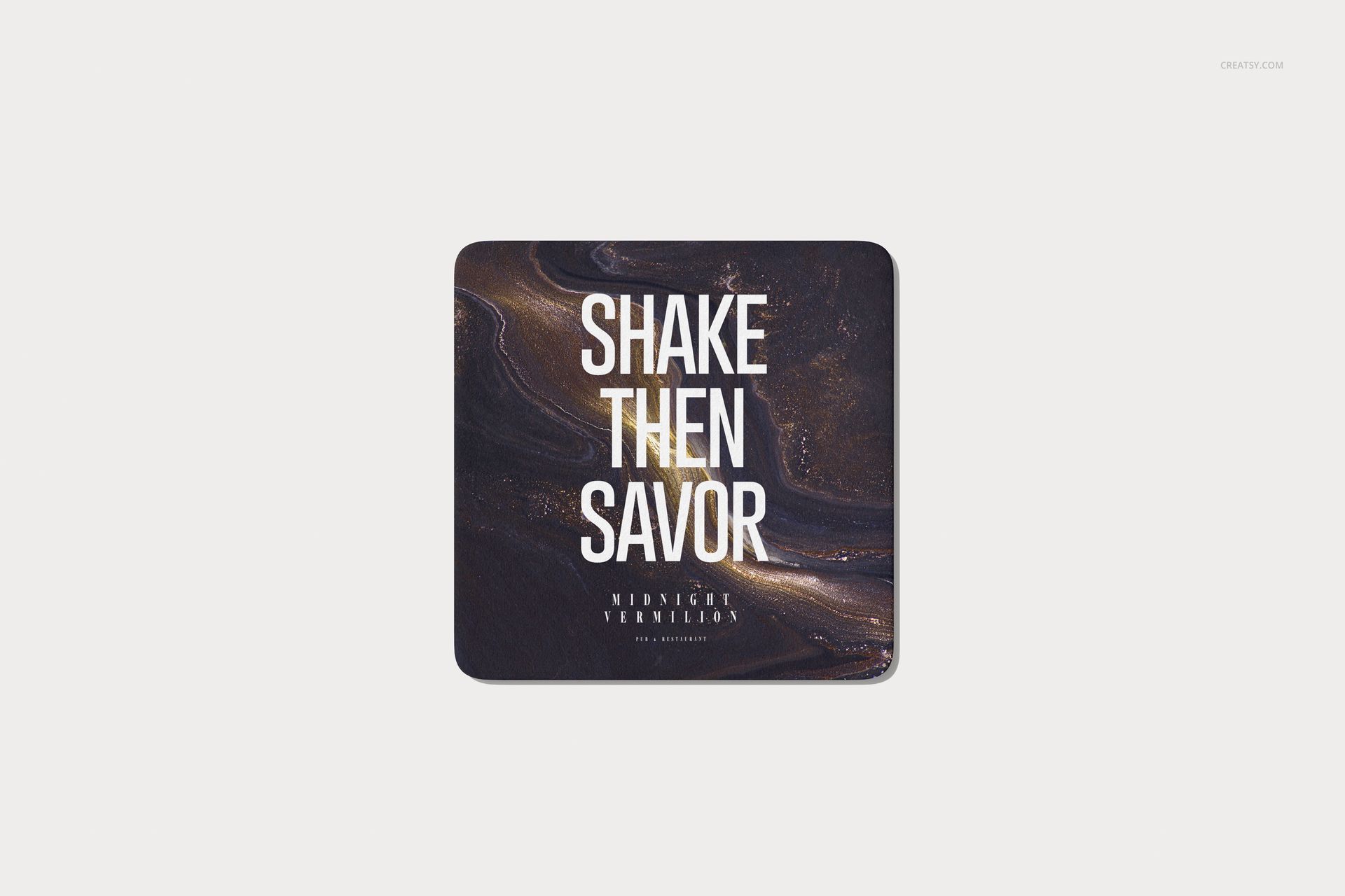 Single square drinkware coaster mockup featuring a swirling black and gold design and centered text, top perspective.