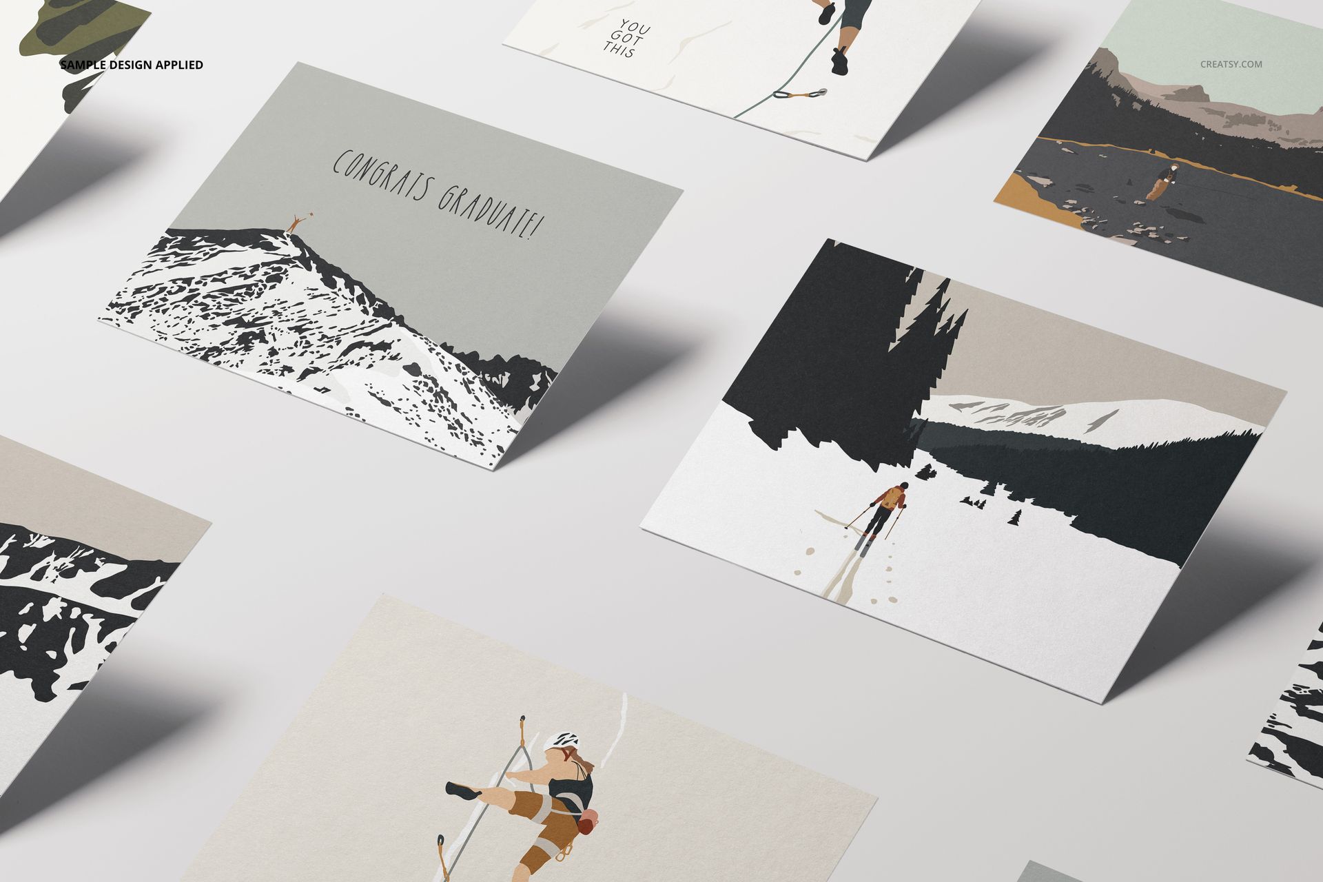 A2 cards mockup set featuring several illustrated greeting cards with winter sports designs, arranged on a light surface.