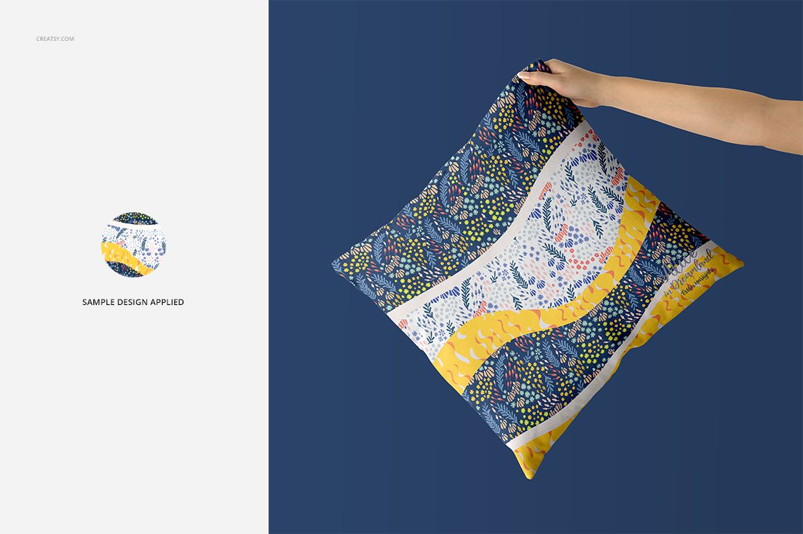 Fabric Factory vol.2 throw pillow PSD mockup showing a patterned cushion with abstract shapes in blue, yellow, and white.