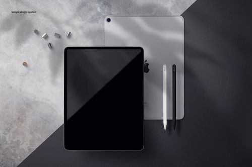 Front and back view of a silver iPad Pro with two styluses on a gray and black surface, shown in a PSD mockup scene.