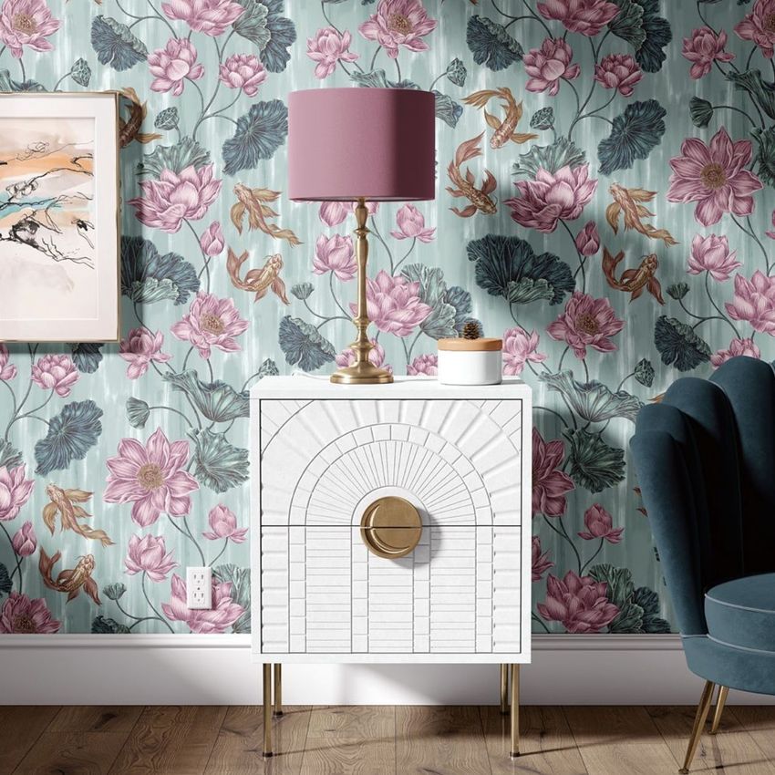 Drum lamp shade mockup with a mauve lampshade on a gold base, placed on a white cabinet against floral wallpaper.