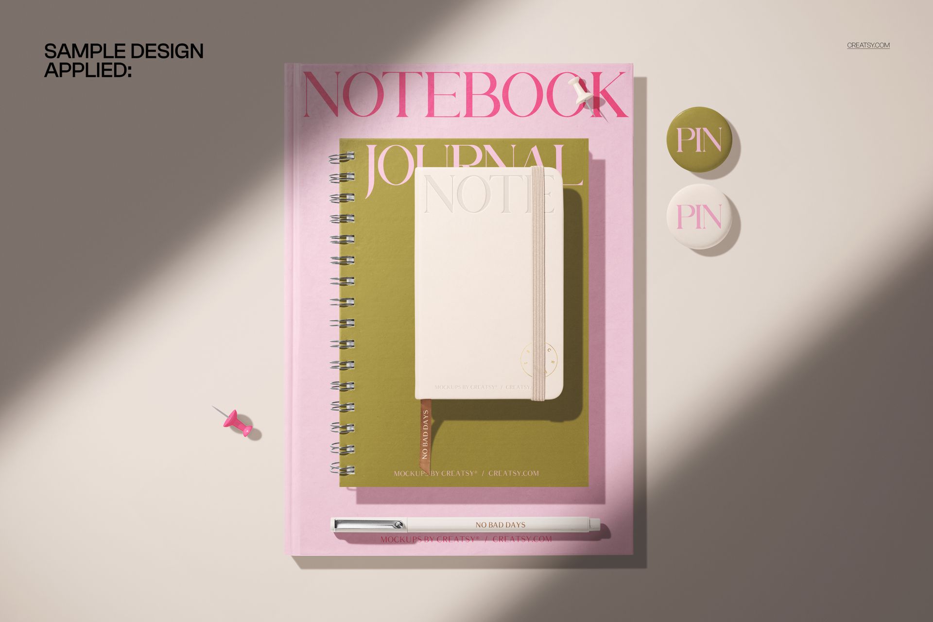Stationery mockup with a spiral-bound journal, hardcover notebook, pocket calendar, and two pins arranged neatly.